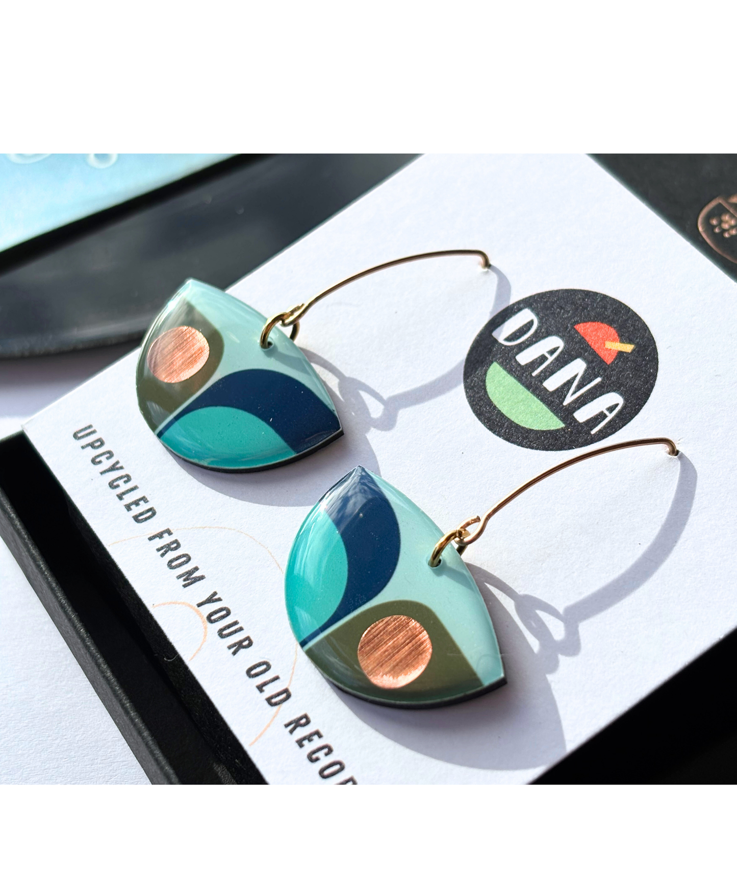 BEA in navy blue, olive green, light teal with a warm pop of copper
