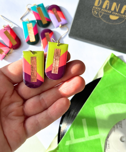 NINA in lime green, deep orange, plum, and copper