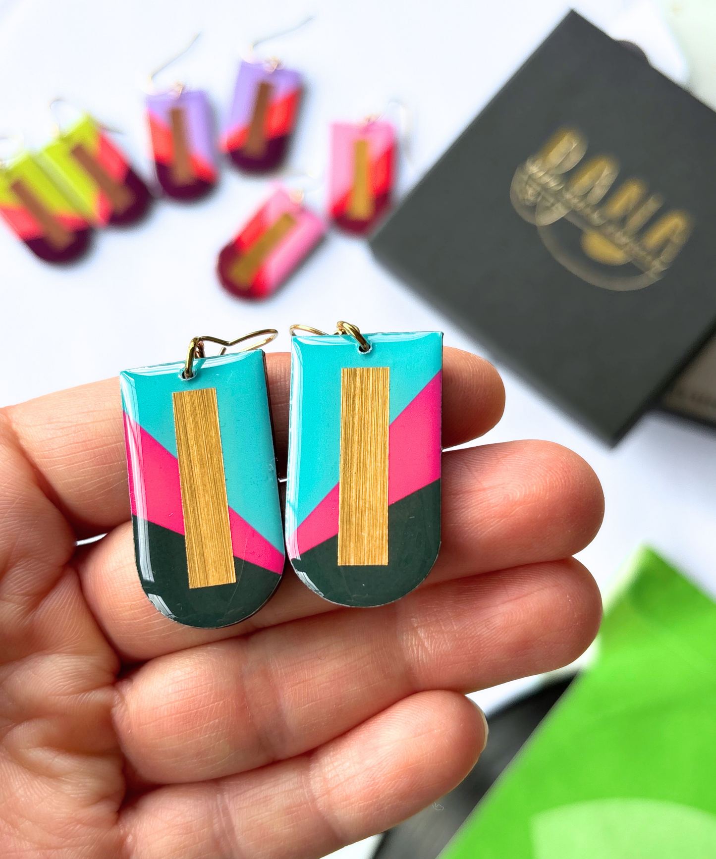 NINA in turquoise, fuchsia, deep khaki, and gold